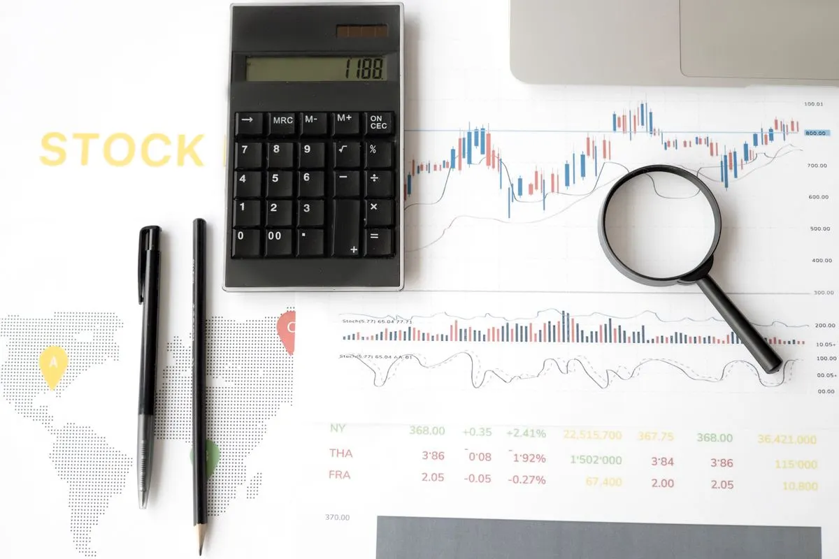 A calculator and magnifying glass on financial documents, representing corporate tax rebate calculations