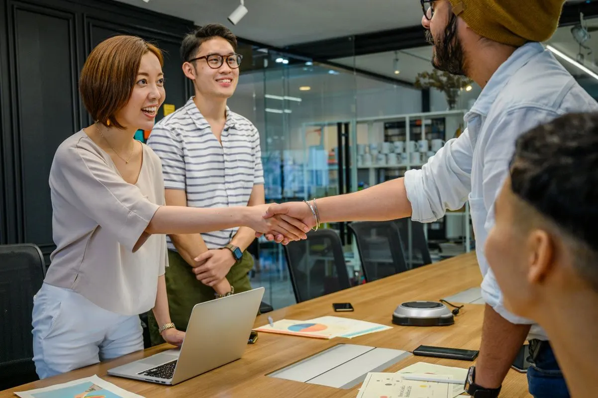 A diverse group of colleagues shaking hands during a productive business meeting
